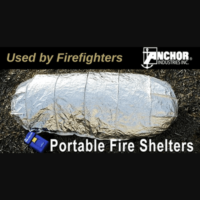 Anchor Industries New Generation Portable Fire Shelters - Natural Disaster Survival Products. Image of the shelter deployed on grass. The color of the shelter is silver, the carrying case is blue.